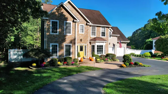 a front view of a house with a yard and potted plants