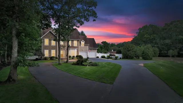 a front view of a house with a garden and garage