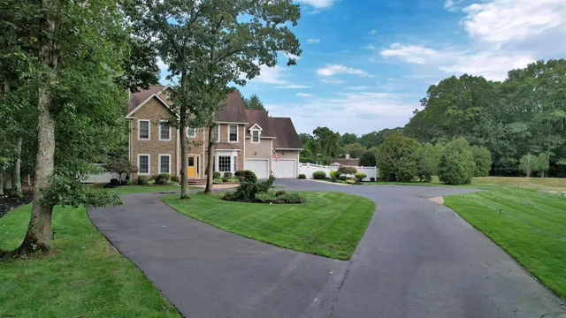 an entryway a dining room and chandelier