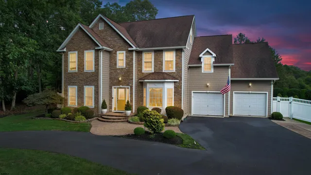 a living room with furniture a bookshelf and a window