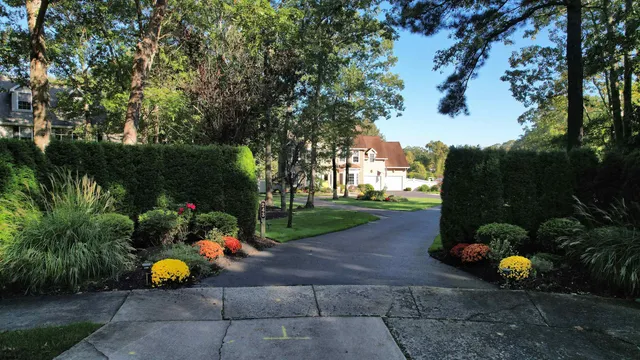a kitchen with stainless steel appliances kitchen island granite countertop a refrigerator a stove and a dining table with wooden floor