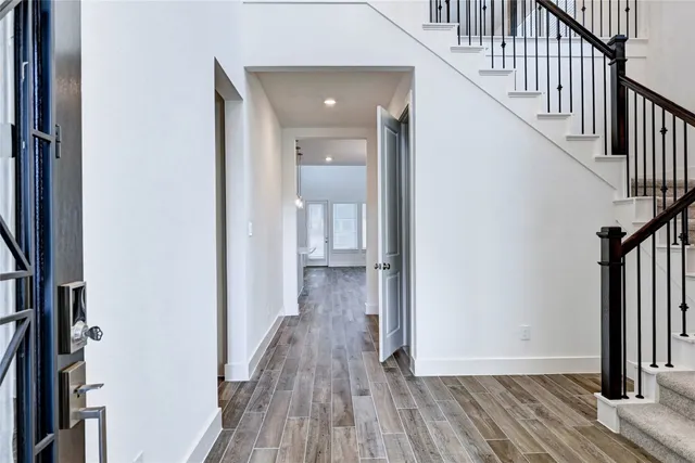 a view of hallway with wooden floor