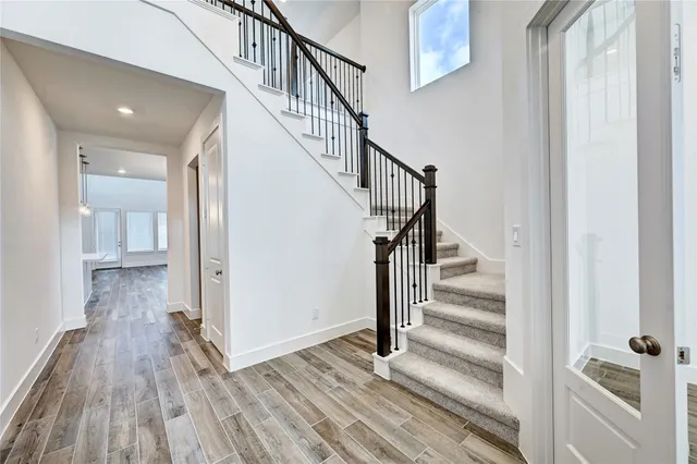 a view of entryway and hall with wooden floor