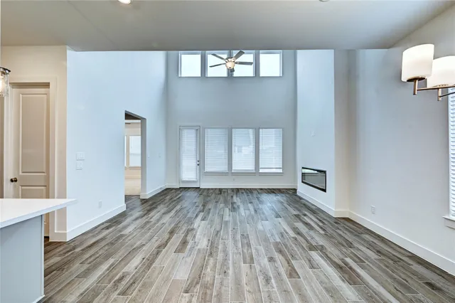 a view of wooden floor and windows in a room
