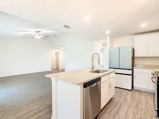 a kitchen with a sink appliances and cabinets
