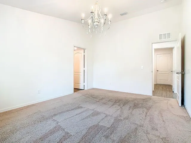 a view of a chandelier fan and a refrigerator in a room