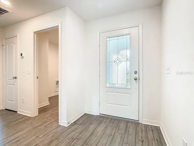 an empty room with wooden floor and closet
