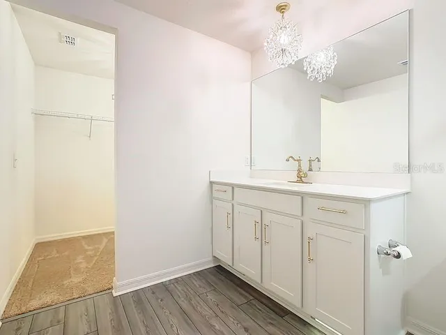 a bathroom with a double vanity sink and a mirror