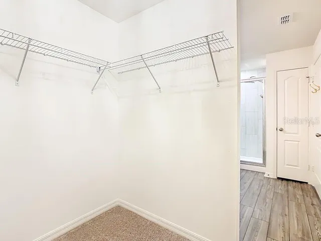 a view of a room with wooden floor
