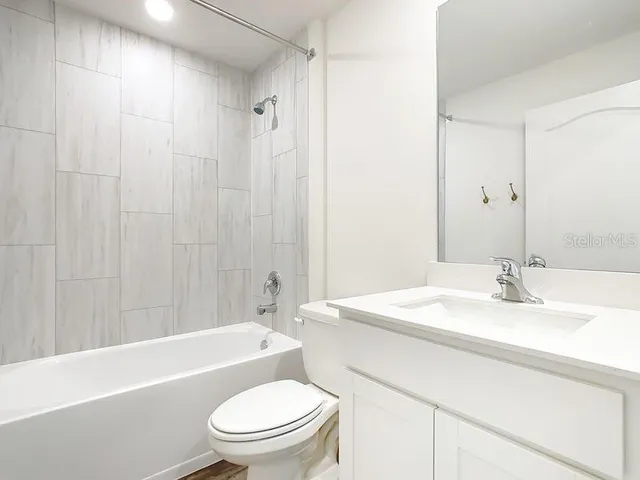 a bathroom with a sink a toilet and a bathtub