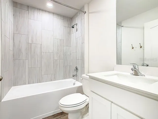 a bathroom with a sink a toilet and a bathtub