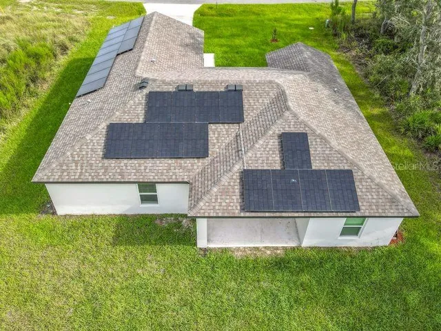 a aerial view of a house with a yard and a garden