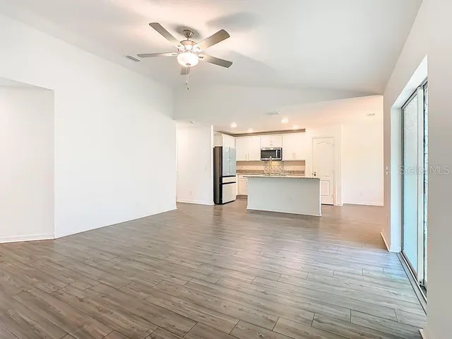 a view of a kitchen with a dishwasher cabinets and wooden floor