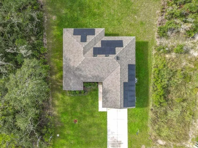 aerial view of a house with a yard