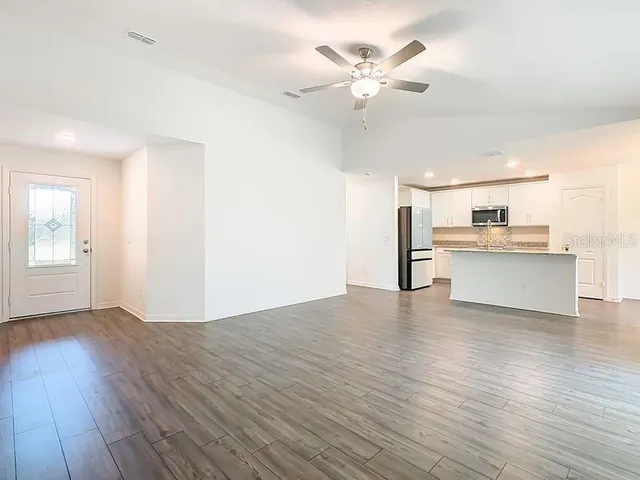a view of a kitchen with wooden floor and a kitchen