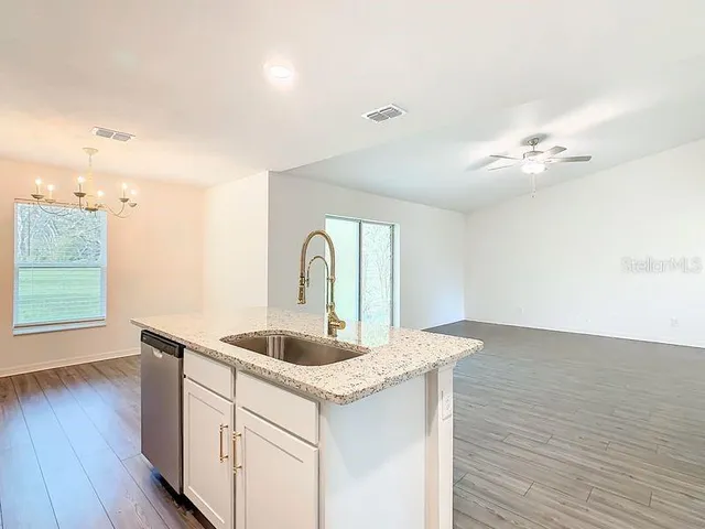 a kitchen with sink and cabinets