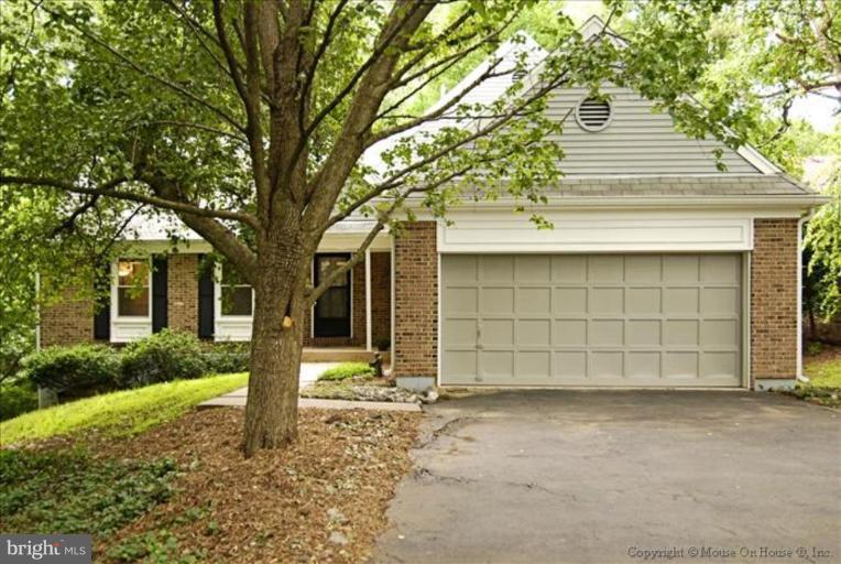 1826 Post Oak Trail Reston, VA 20191 - Photo 1 of 28 a front view of a house with a yard and garage