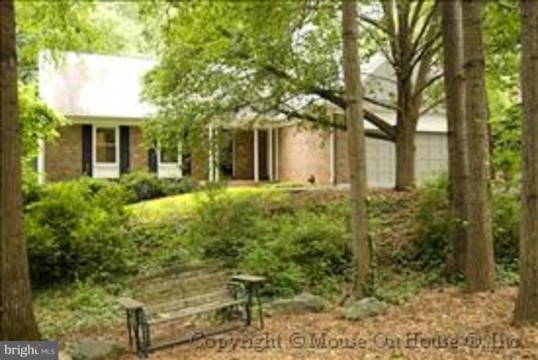 1826 Post Oak Trail Reston, VA 20191 - Photo 2 of 28 a front view of a house with garden