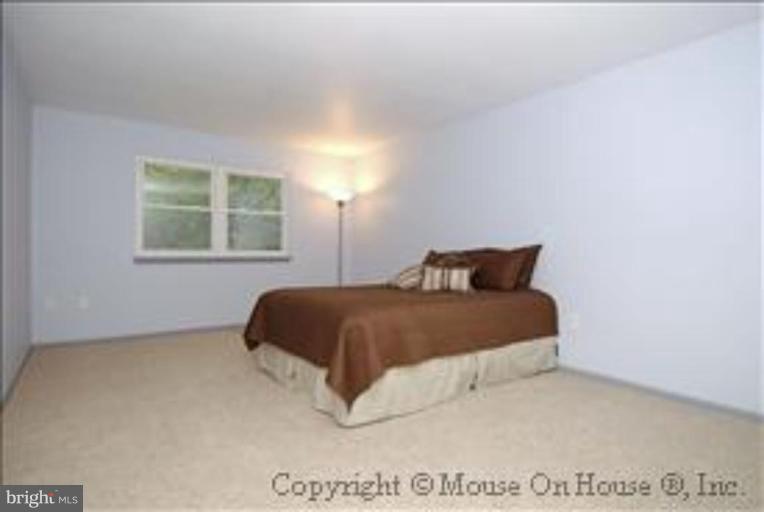 1826 Post Oak Trail Reston, VA 20191 - Photo 11 of 28 a bedroom with a bed and a window