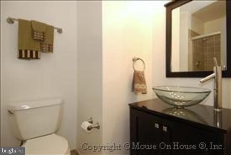 1826 Post Oak Trail Reston, VA 20191 - Photo 12 of 28 a bathroom with a toilet a sink and mirror