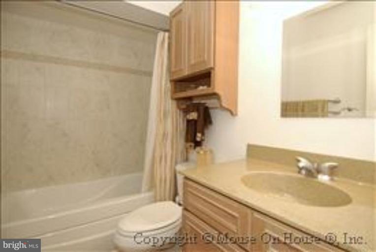 1826 Post Oak Trail Reston, VA 20191 - Photo 20 of 28 a bathroom with a granite countertop bathtub shower sink vanity and toilet