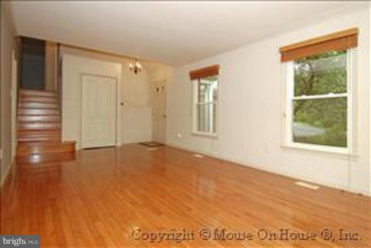 1826 Post Oak Trail Reston, VA 20191 - Photo 4 of 28 a view of an empty room with a window and wooden floor