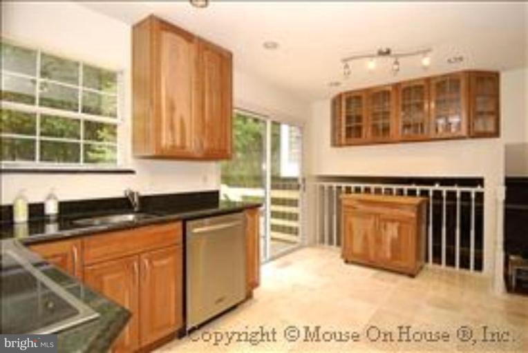 1826 Post Oak Trail Reston, VA 20191 - Photo 7 of 28 a kitchen with granite countertop a stove a sink and a granite counter tops