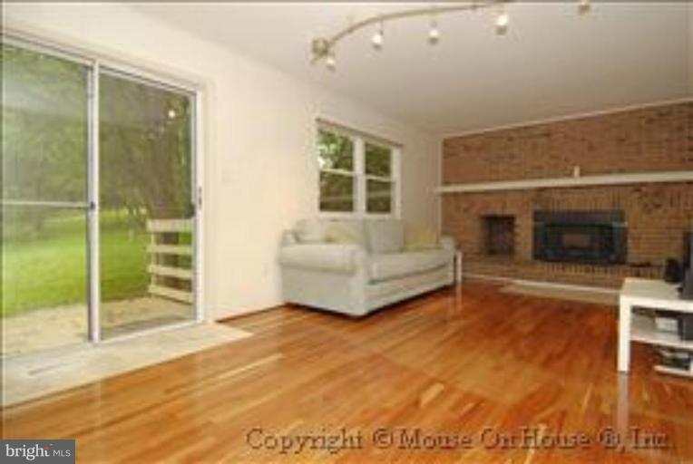 1826 Post Oak Trail Reston, VA 20191 - Photo 8 of 28 a living room with furniture and a fireplace