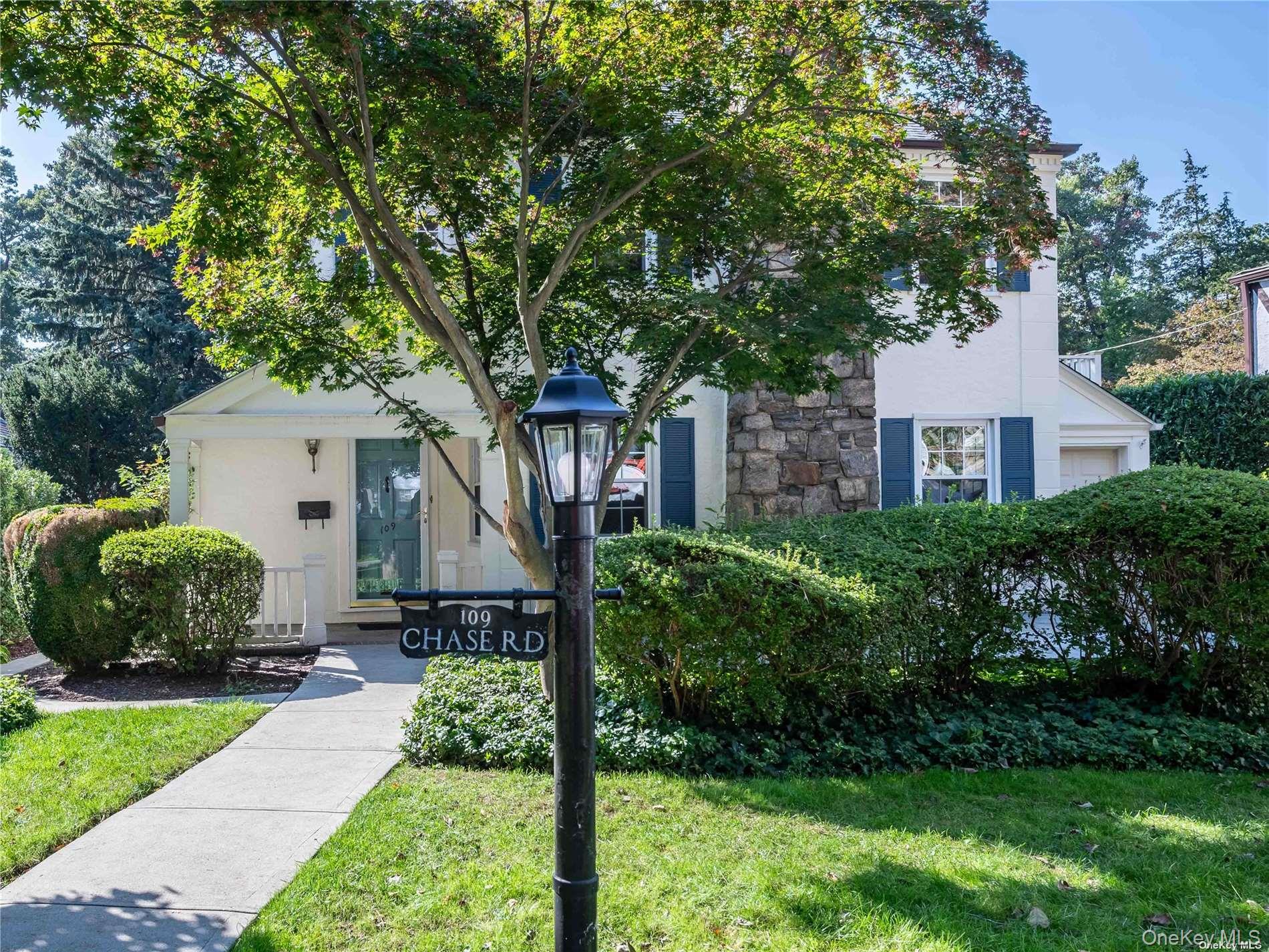 109 Chase Road Manhasset, NY 11030 - Photo 1 of 28 a front view of a house with a garden