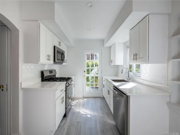 a kitchen with a sink stove and cabinets