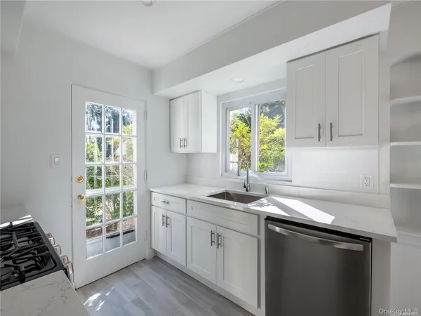 a view of a room with window and hardwood floor