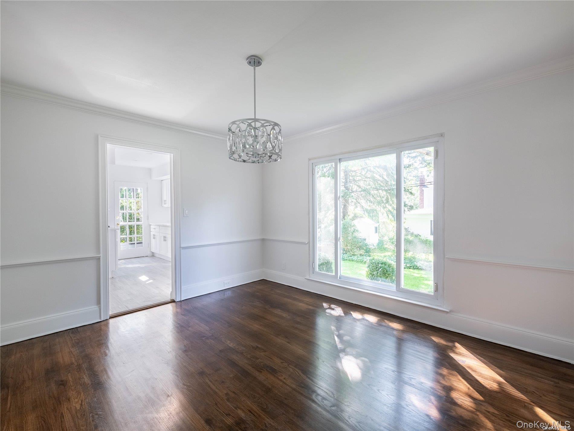 109 Chase Road Manhasset, NY 11030 - Photo 18 of 28 a view of an empty room with wooden floor and a window