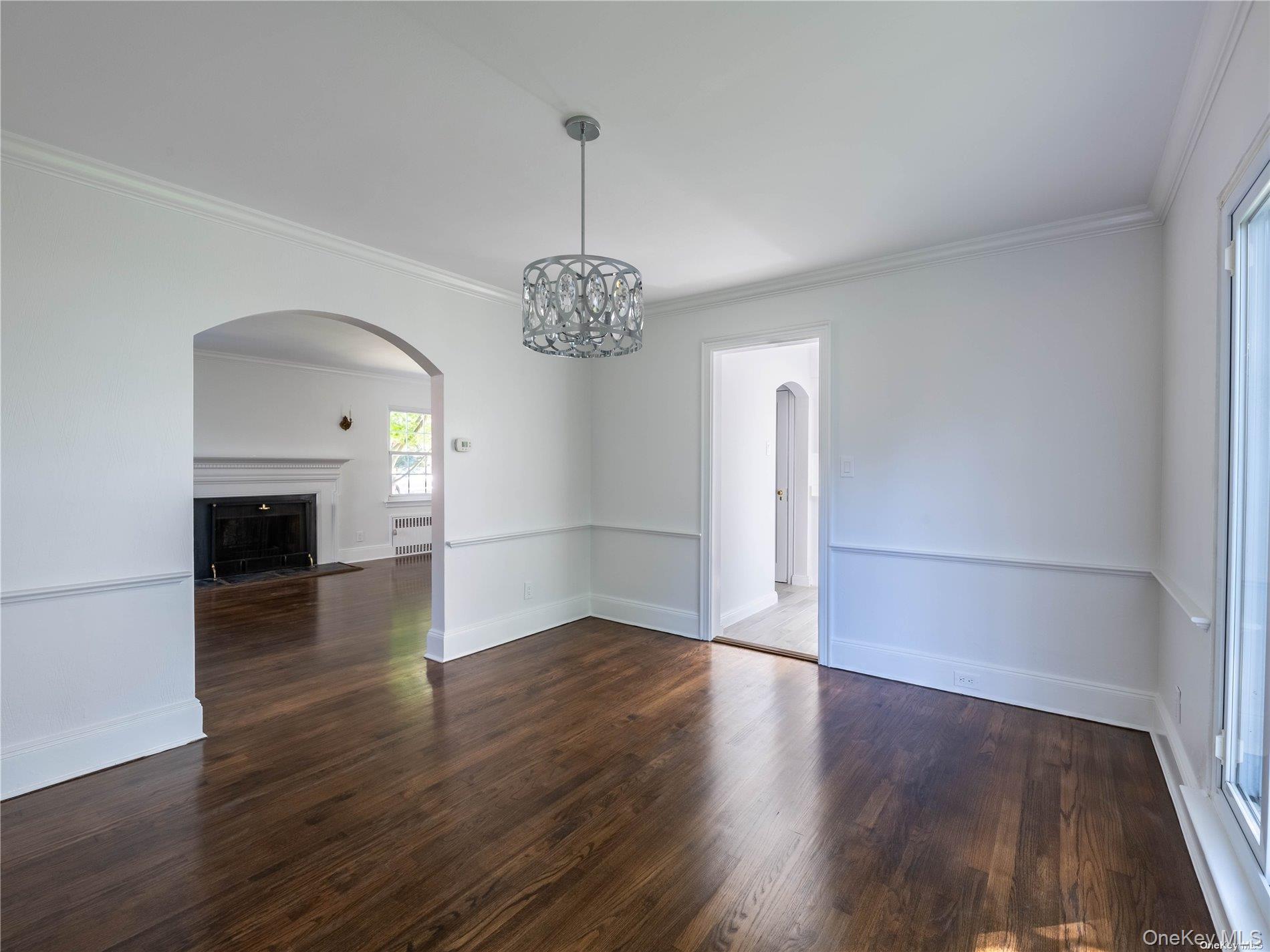 109 Chase Road Manhasset, NY 11030 - Photo 19 of 28 a view of a room with wooden floor fireplace and windows