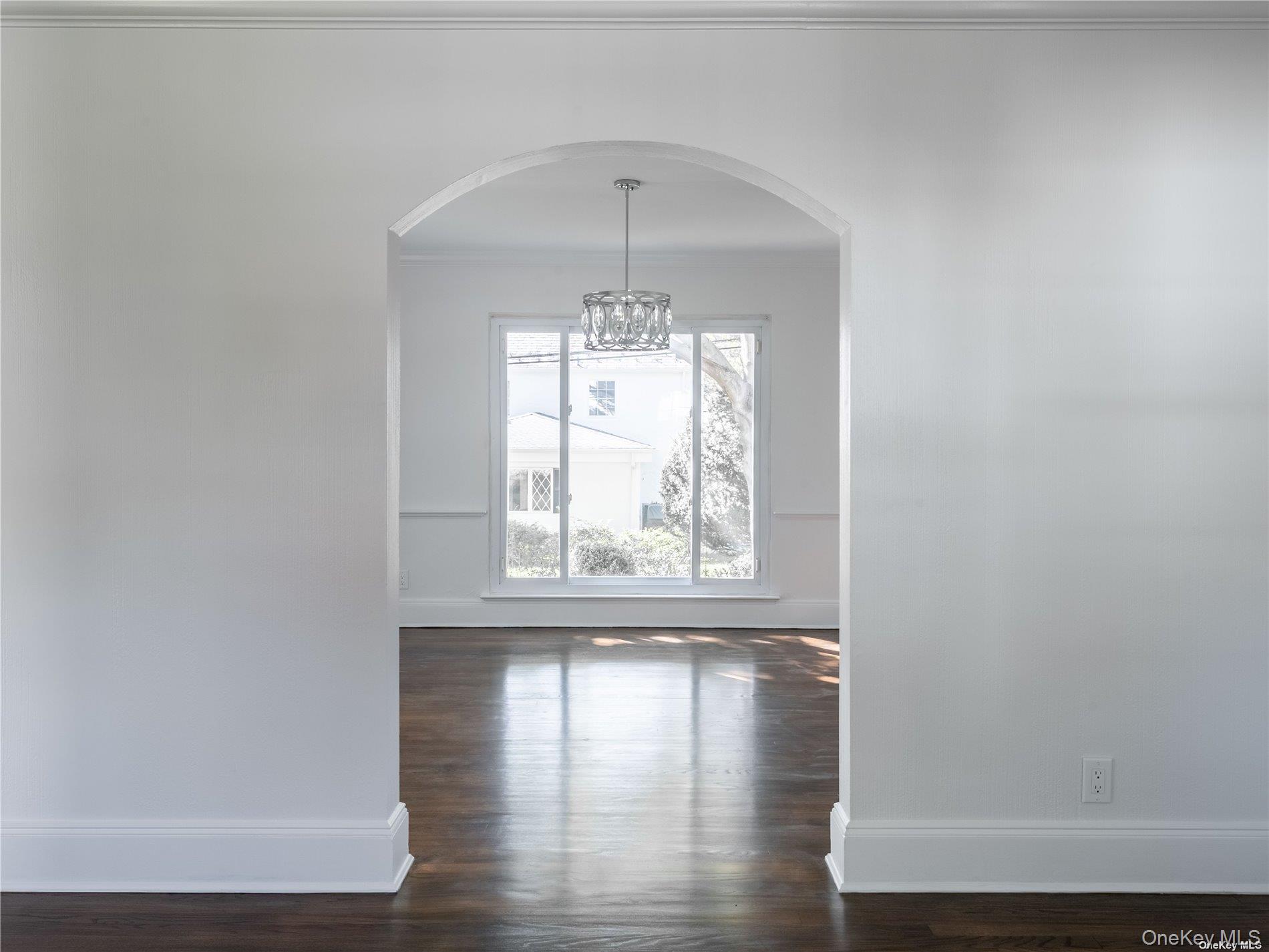 109 Chase Road Manhasset, NY 11030 - Photo 20 of 28 a view of an empty room with wooden floor and a window