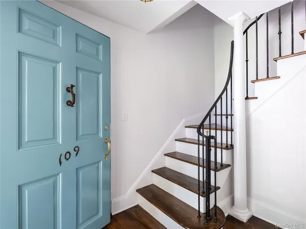 a view of entryway with wooden floor and stairs