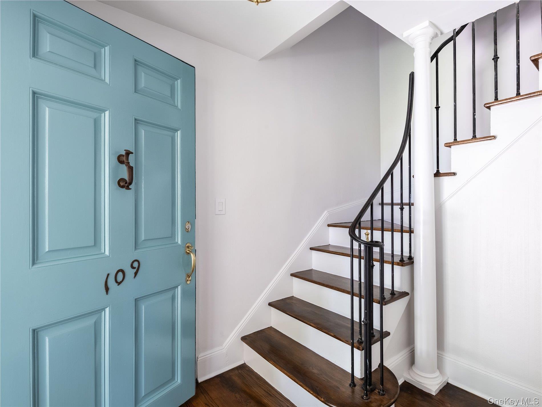 109 Chase Road Manhasset, NY 11030 - Photo 2 of 28 a view of entryway with wooden floor and stairs