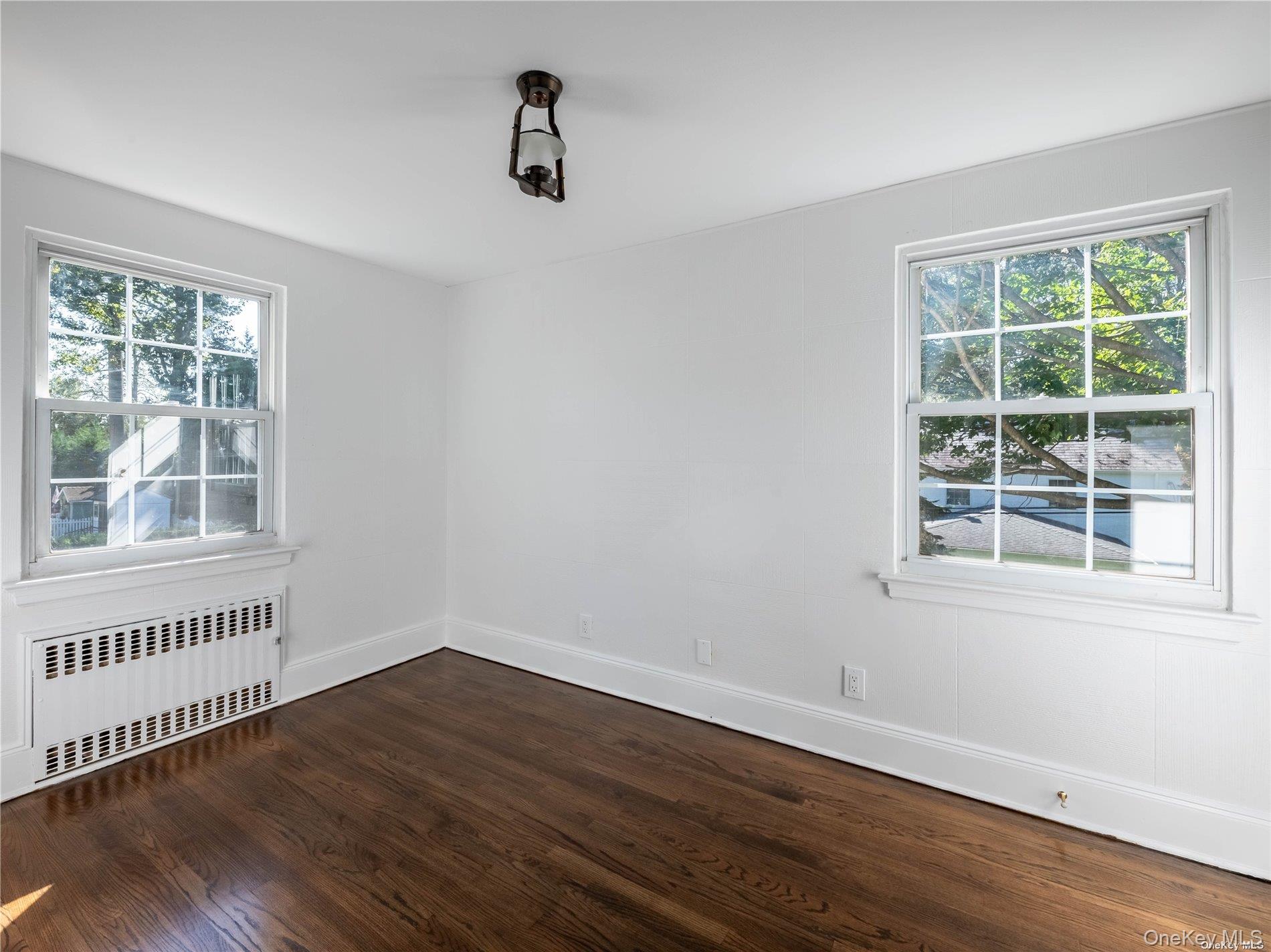 109 Chase Road Manhasset, NY 11030 - Photo 25 of 28 a view of an empty room with wooden floor and a window