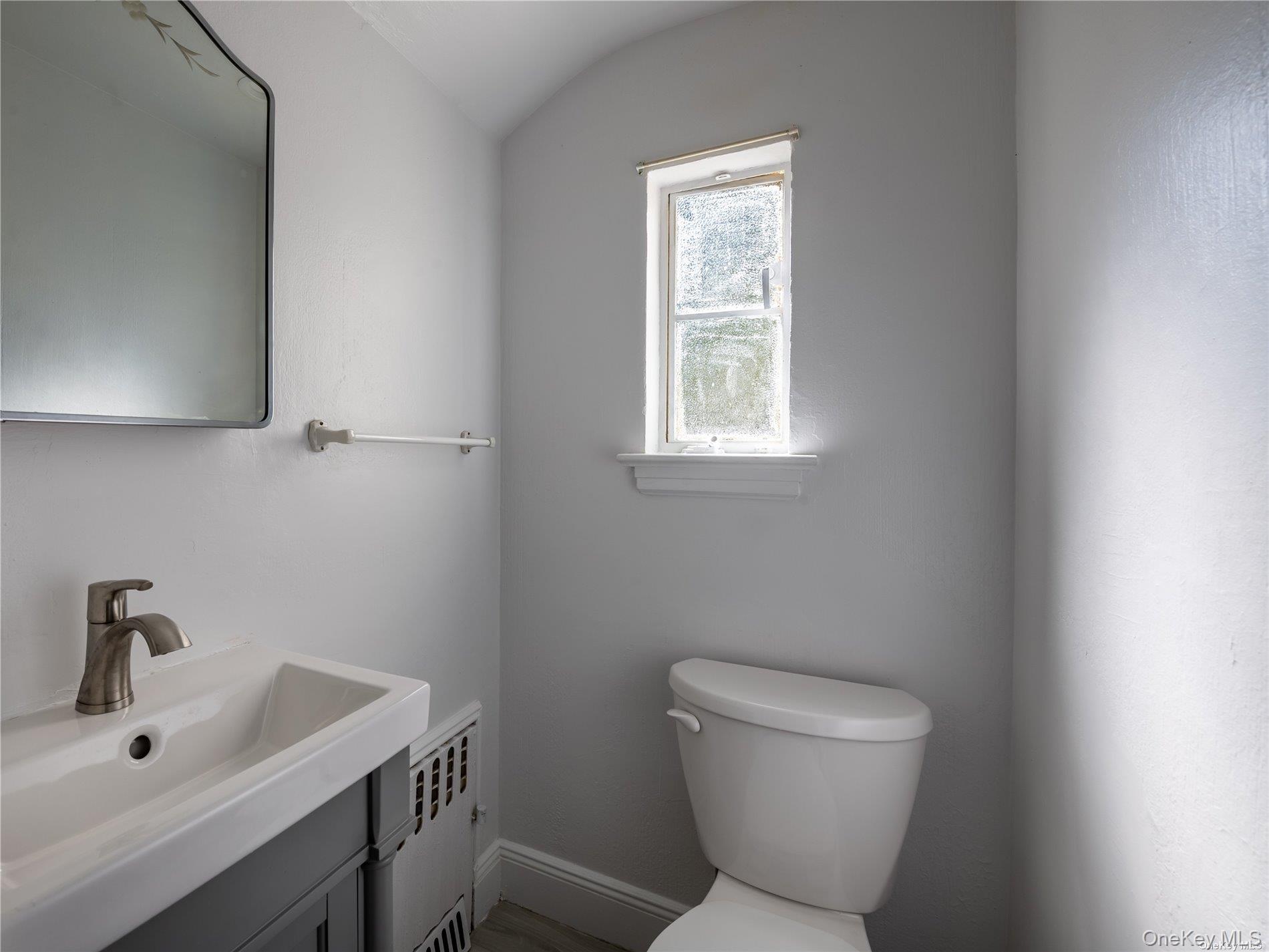 109 Chase Road Manhasset, NY 11030 - Photo 26 of 28 a bathroom with a toilet sink and mirror