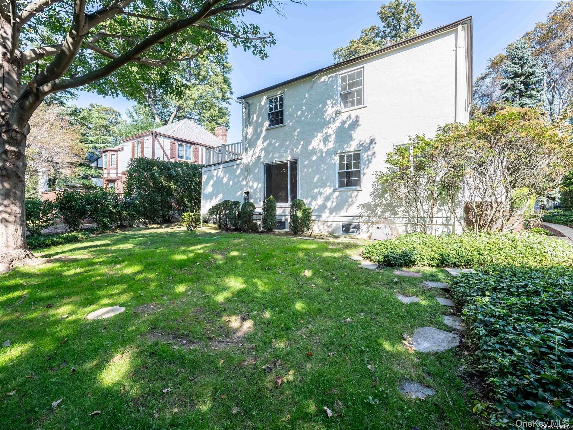 109 Chase Road Manhasset, NY 11030 - Photo 5 of 28 a view of a house with a yard