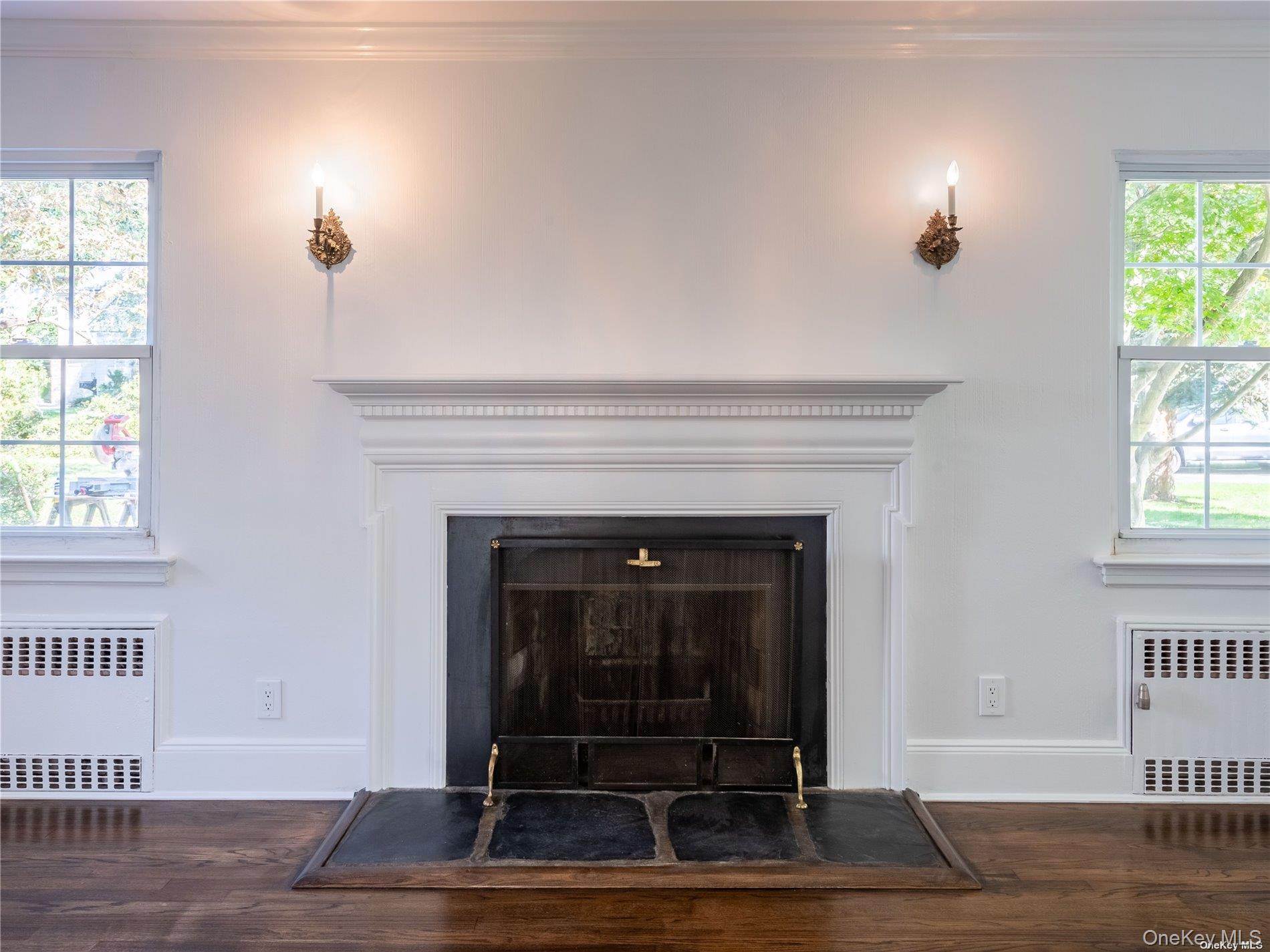 109 Chase Road Manhasset, NY 11030 - Photo 9 of 28 a living room with a fireplace and a window