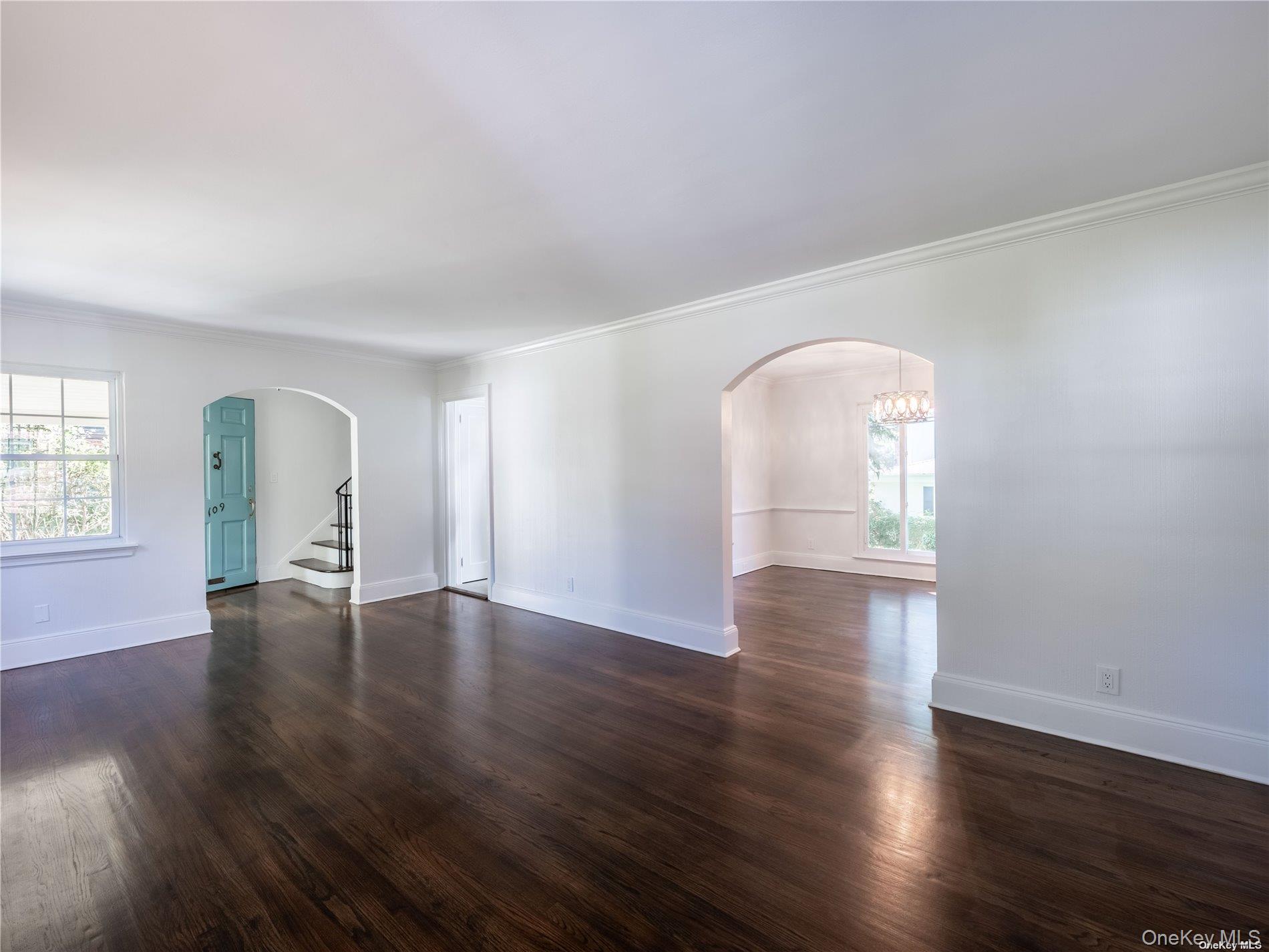 109 Chase Road Manhasset, NY 11030 - Photo 10 of 28 an empty room with wooden floor and windows