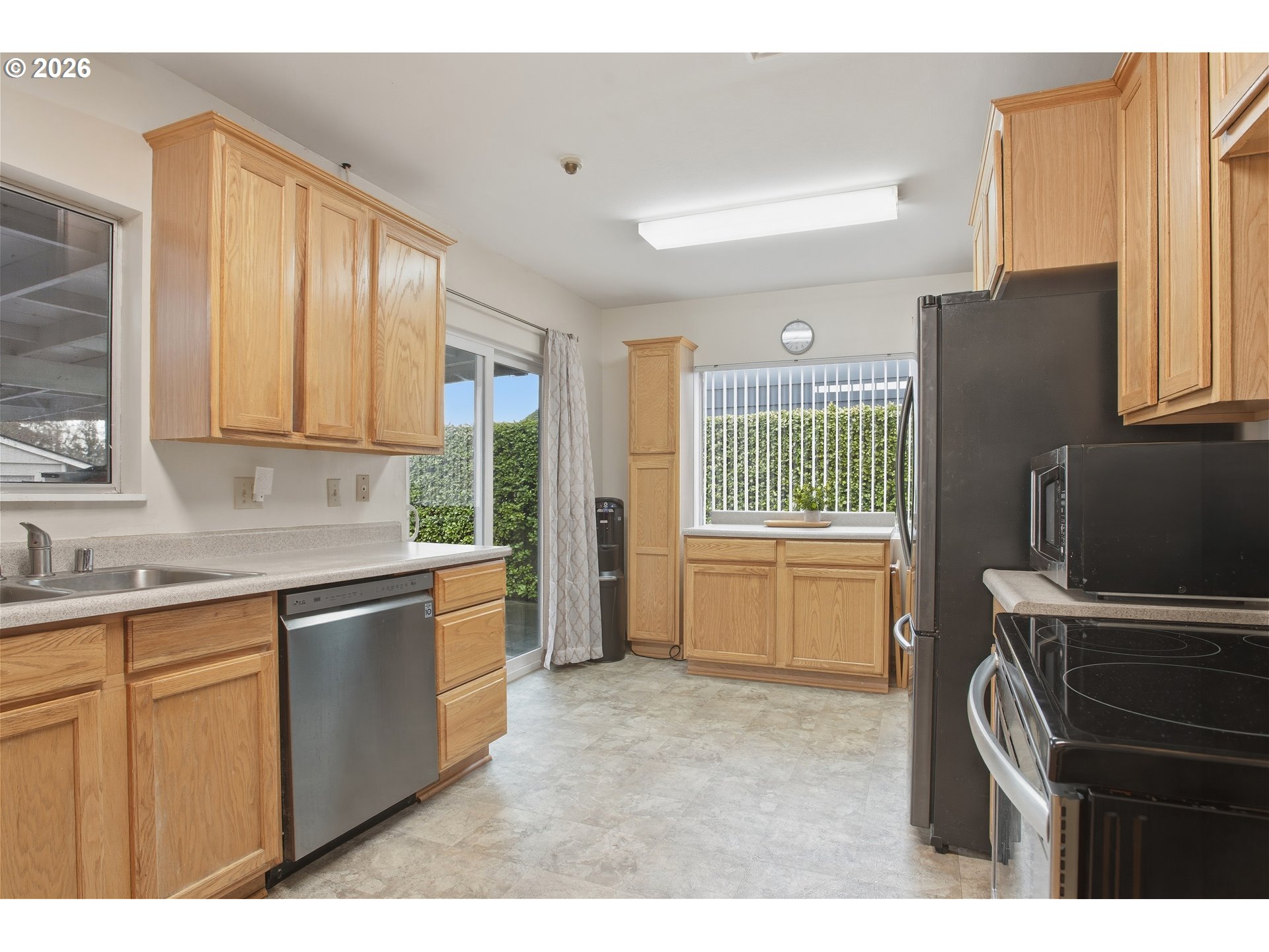 3506 Columbia Heights Road Longview, WA 98632 - Photo 9 of 21 a kitchen that has a sink cabinets appliances and a window