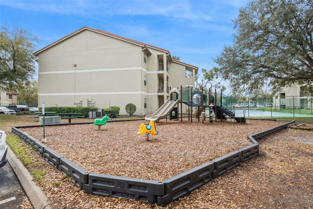 3032 Parkway Boulevard, Unit 305 Kissimmee, FL 34747 - Photo 29 of 40 a view of a backyard with chairs