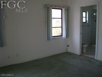 223 Danby Road Lehigh Acres, FL 33936 - Photo 8 of 10 an empty room with a window