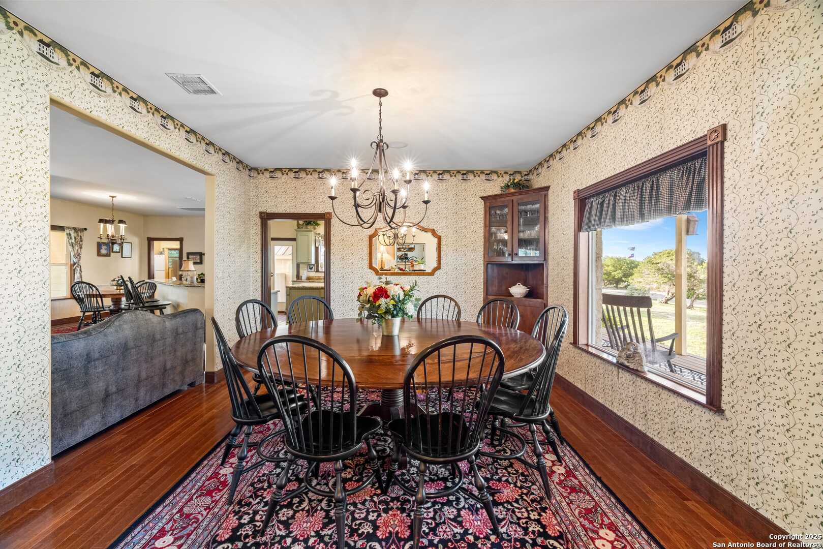 247 Huntleigh Road South Ingram, TX 78025 - Photo 18 of 41 a view of a dining room with furniture window and wooden floor