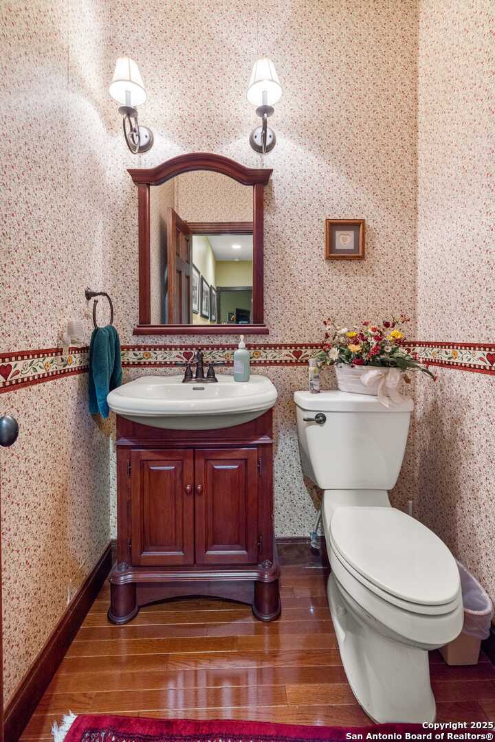 247 Huntleigh Road South Ingram, TX 78025 - Photo 23 of 41 a bathroom with a toilet a sink and mirror