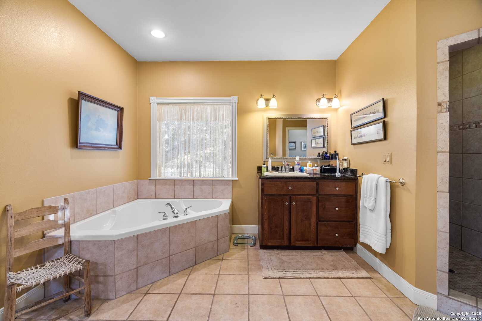 247 Huntleigh Road South Ingram, TX 78025 - Photo 27 of 41 a spacious bathroom with a tub a sink and mirror