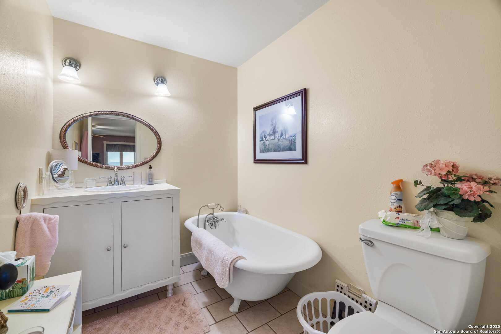 247 Huntleigh Road South Ingram, TX 78025 - Photo 33 of 41 a bathroom with a toilet a sink and mirror
