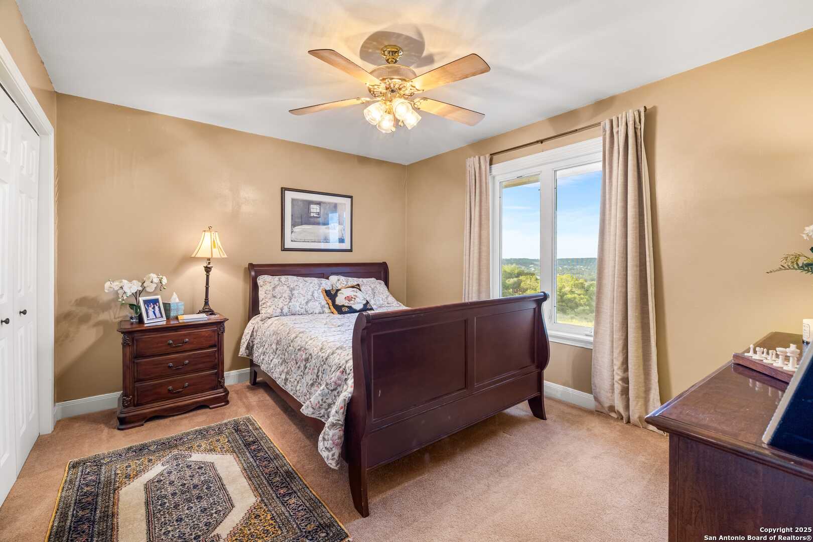 247 Huntleigh Road South Ingram, TX 78025 - Photo 34 of 41 a bedroom with a bed and a chandelier
