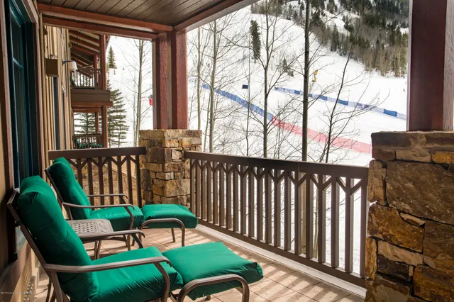 a two chairs sitting in a balcony